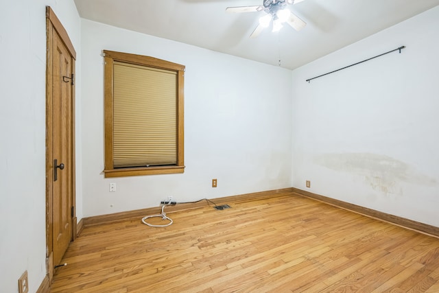 empty room with light wood-type flooring and ceiling fan