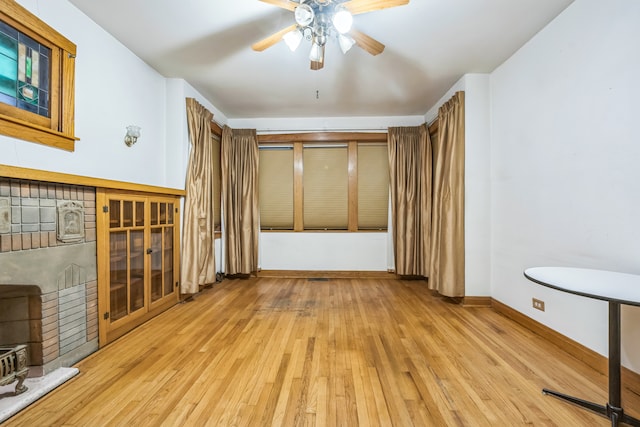 interior space with light wood-type flooring and ceiling fan