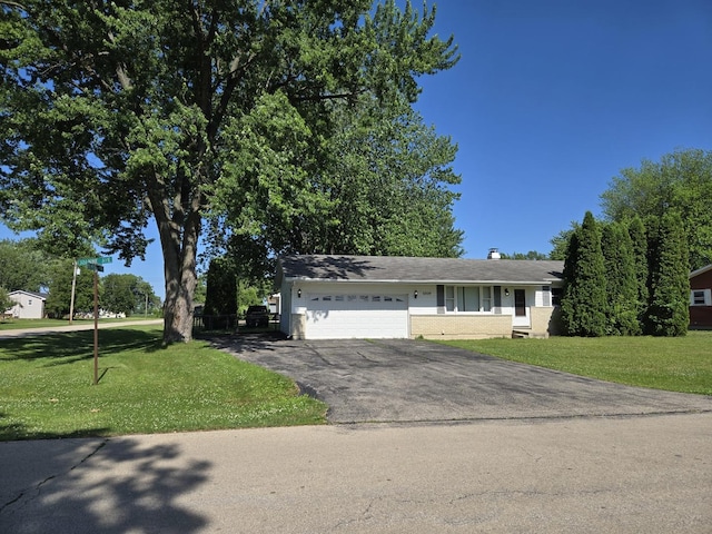 6809 S Joanne Ave, Rochelle, IL 61068 - view of front of house with a garage, driveway, a front lawn, a chimney, and brick siding