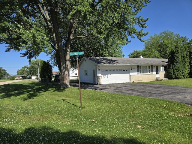 6809 S Joanne Ave, Rochelle, IL 61068 - view of front of home featuring driveway, an attached garage, and a front yard