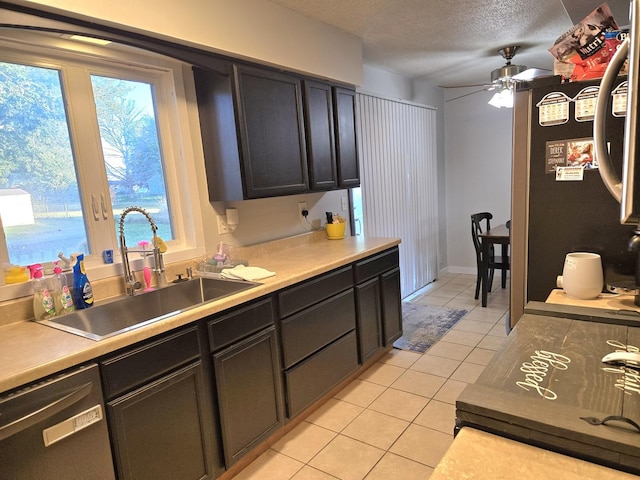 6809 S Joanne Ave, Rochelle, IL 61068 - kitchen featuring dishwasher, light tile patterned floors, ceiling fan, a textured ceiling, and light countertops