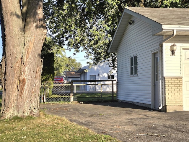 6809 S Joanne Ave, Rochelle, IL 61068 - view of side of property with brick siding and roof with shingles