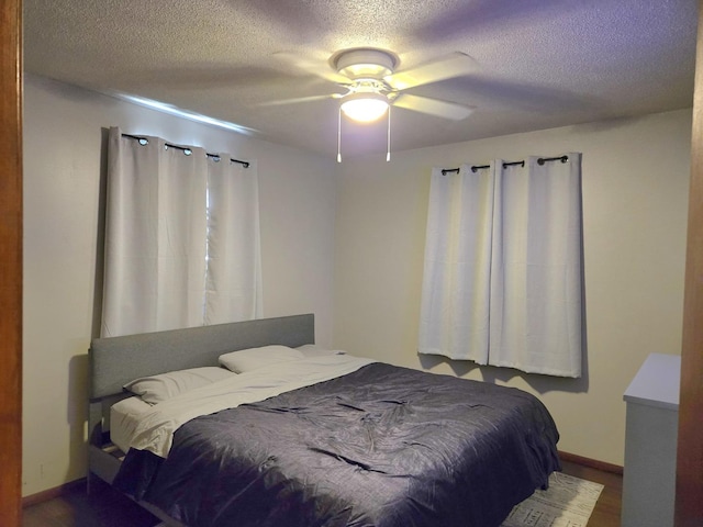 6809 S Joanne Ave, Rochelle, IL 61068 - bedroom with a textured ceiling, a ceiling fan, and wood finished floors