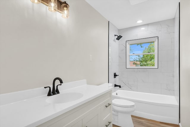 full bathroom with wood-type flooring, vanity, toilet, and tiled shower / bath