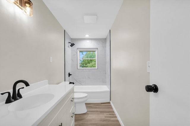 full bathroom with wood-type flooring, vanity, toilet, and tiled shower / bath