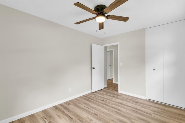 unfurnished bedroom featuring ceiling fan, light hardwood / wood-style flooring, and a closet