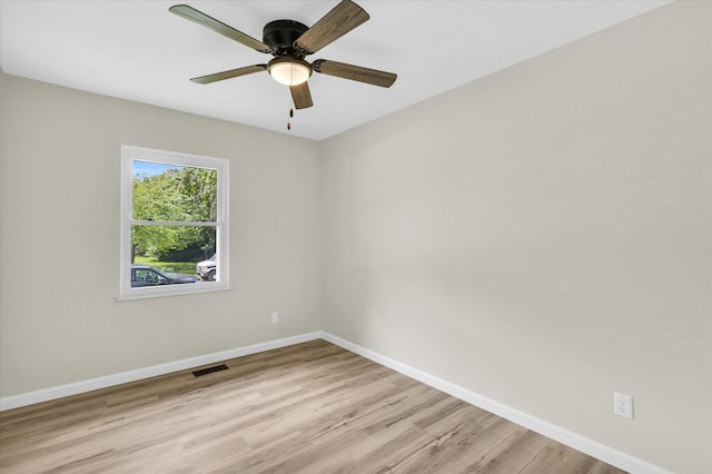 spare room featuring light hardwood / wood-style floors and ceiling fan