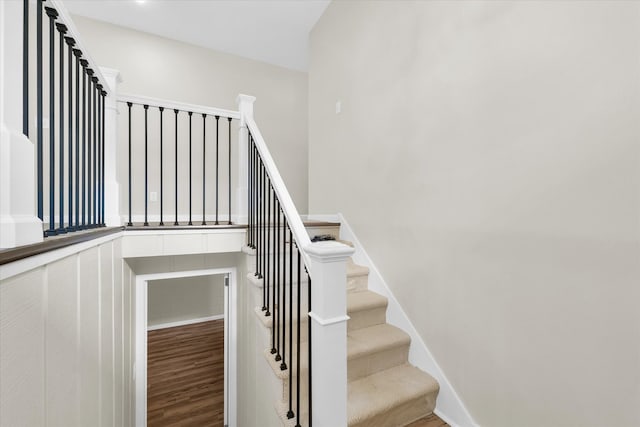 stairway featuring wood-type flooring