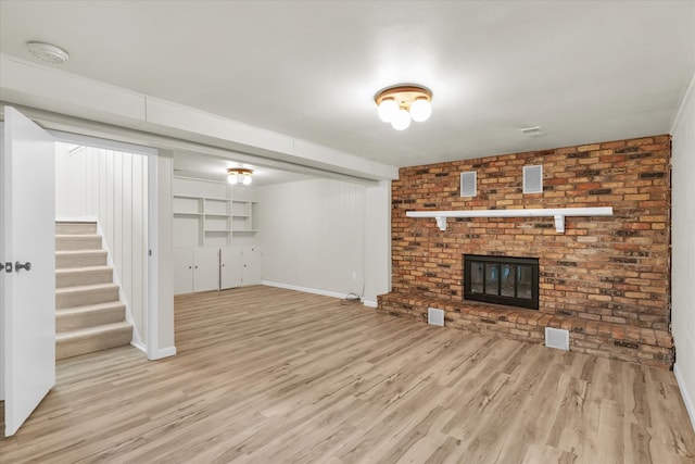 unfurnished living room featuring light hardwood / wood-style flooring and a fireplace