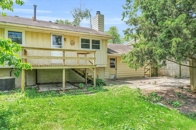 rear view of house featuring a lawn, a patio, a deck, and cooling unit