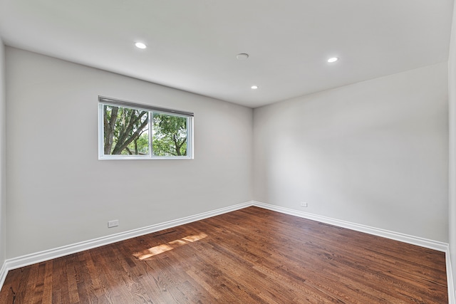 unfurnished room with wood-type flooring