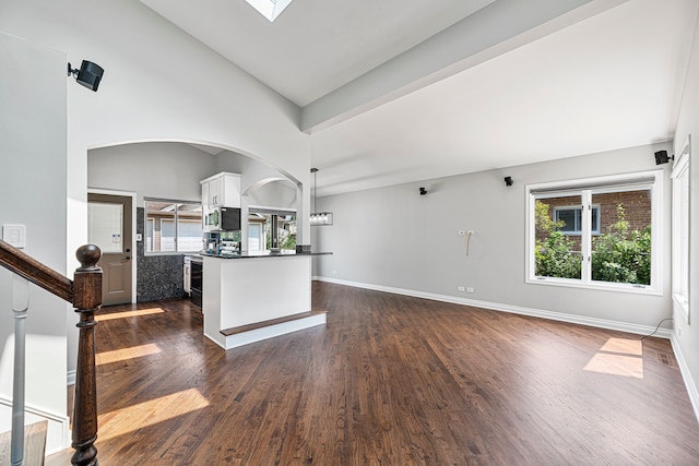 interior space with high vaulted ceiling and dark hardwood / wood-style flooring