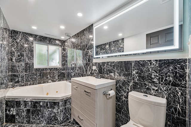 bathroom featuring tiled bath, vanity, tile walls, and toilet