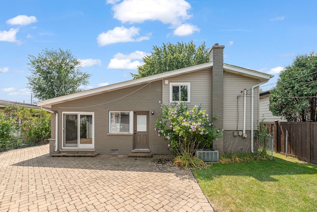 back of house with a lawn, a patio, and central AC unit