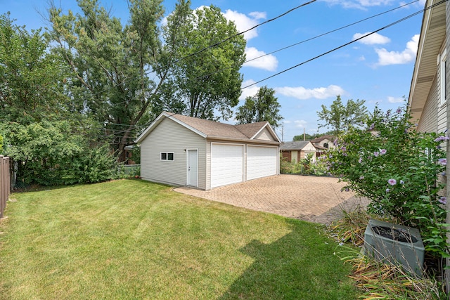 garage featuring a lawn and central air condition unit