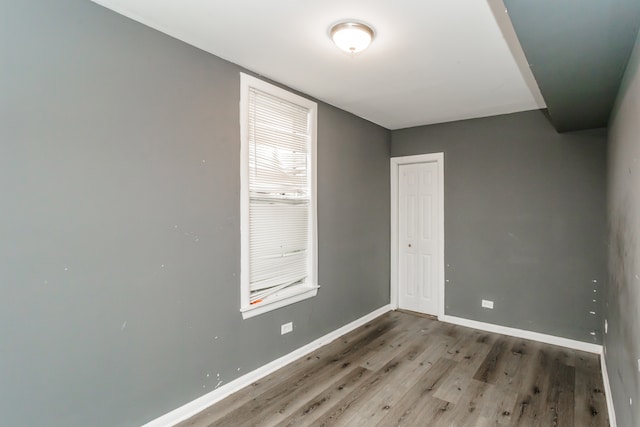 unfurnished room with hardwood / wood-style flooring