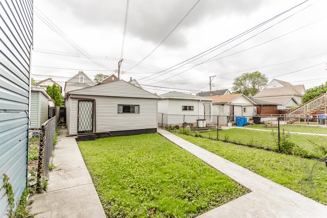 exterior space featuring an outdoor structure and a yard