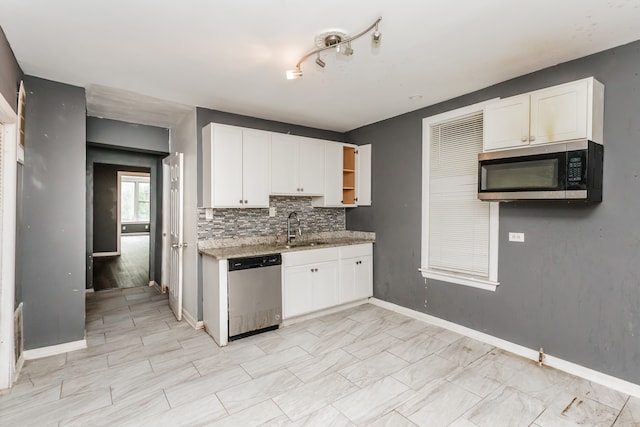 kitchen with stainless steel appliances, white cabinetry, and sink