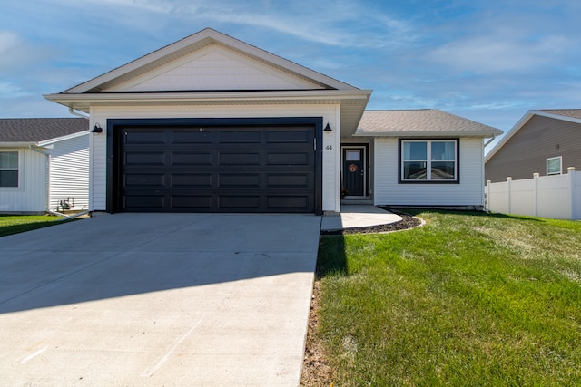 ranch-style home with a garage and a front yard