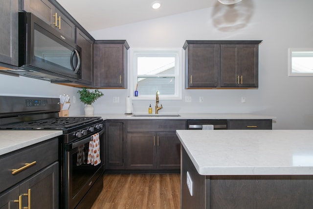 kitchen featuring sink, dark brown cabinets, black appliances, vaulted ceiling, and dark hardwood / wood-style flooring