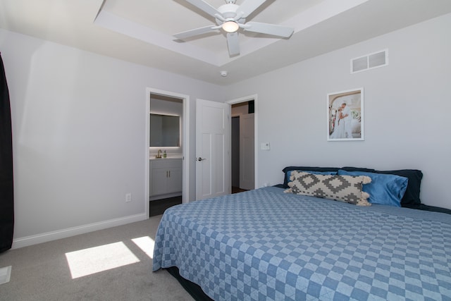 carpeted bedroom with ensuite bath, ceiling fan, and sink