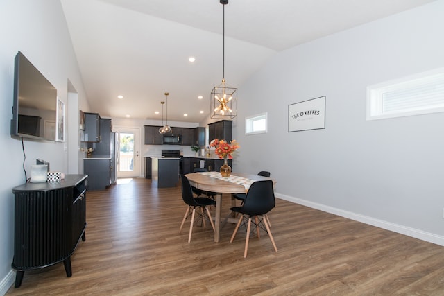 dining space with vaulted ceiling, a chandelier, and dark wood-type flooring