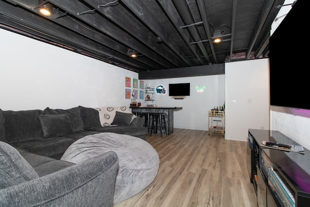 living room with hardwood / wood-style flooring and bar