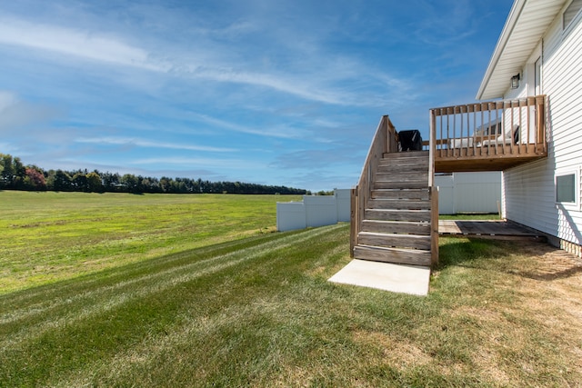 view of yard with a deck and a rural view