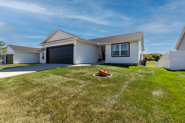 ranch-style house featuring a garage and a front yard