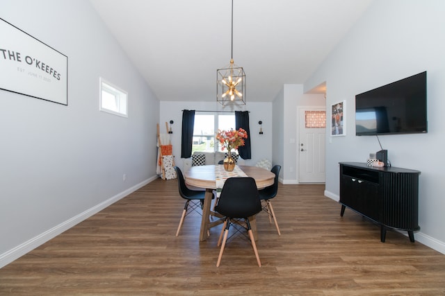 dining space with lofted ceiling, an inviting chandelier, and dark wood-type flooring