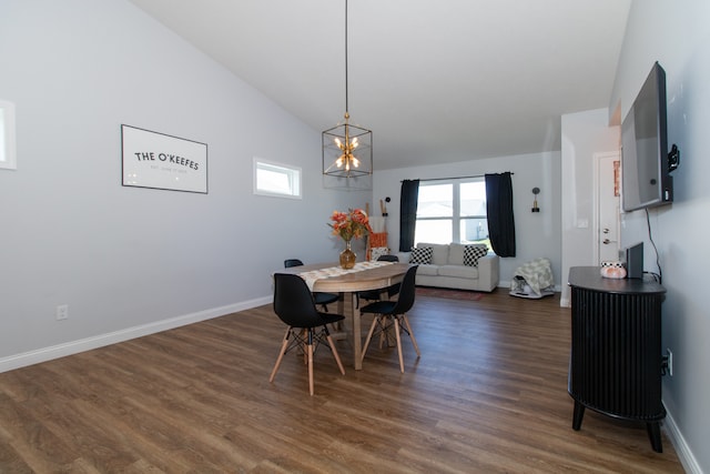 dining space with lofted ceiling, a chandelier, and dark hardwood / wood-style flooring