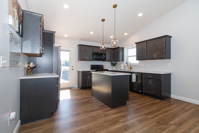 kitchen with pendant lighting, black range, a center island, vaulted ceiling, and dark hardwood / wood-style flooring