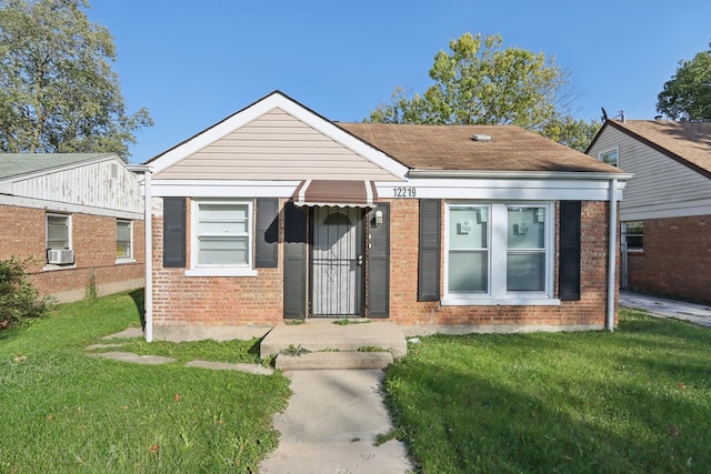 bungalow-style home with cooling unit and a front lawn