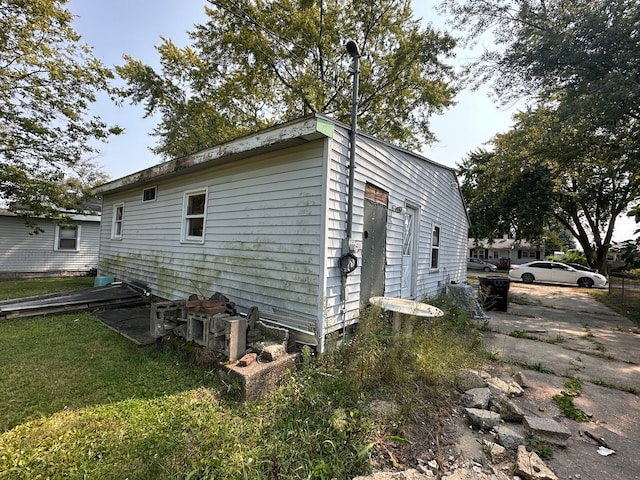 view of property exterior with a yard