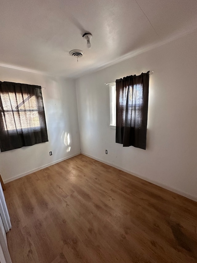 spare room featuring hardwood / wood-style flooring