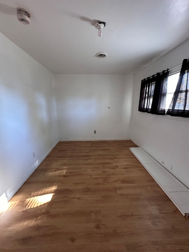 empty room with dark hardwood / wood-style flooring