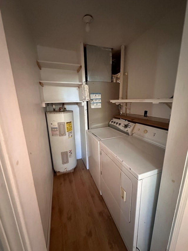 washroom featuring hardwood / wood-style floors, water heater, and washing machine and clothes dryer