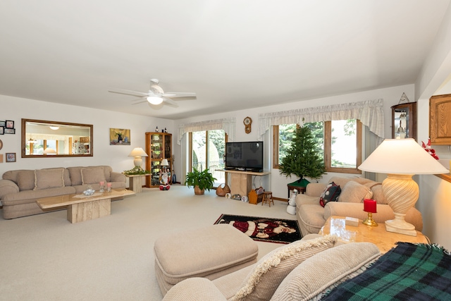 carpeted living room featuring ceiling fan