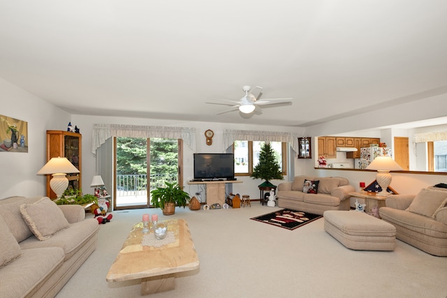 living room with ceiling fan and carpet floors