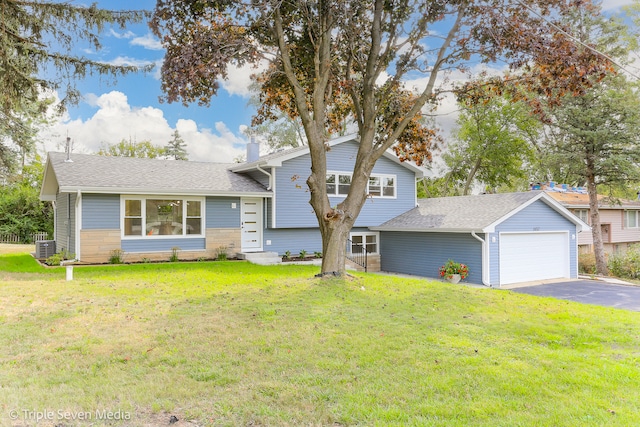 tri-level home featuring central AC, a front yard, and a garage