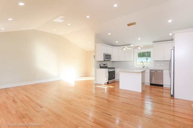 kitchen with appliances with stainless steel finishes, light wood-type flooring, and white cabinetry