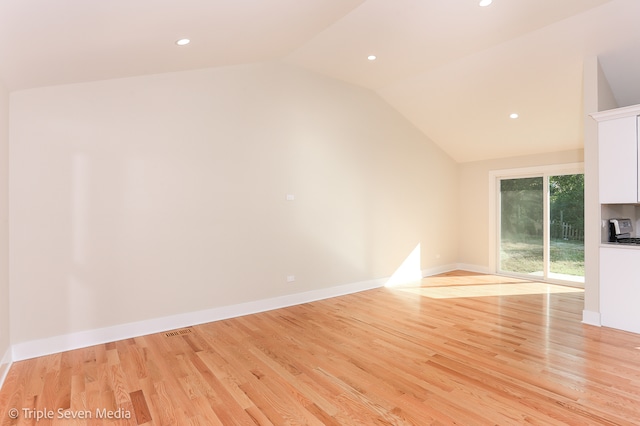 unfurnished living room featuring light hardwood / wood-style floors and lofted ceiling