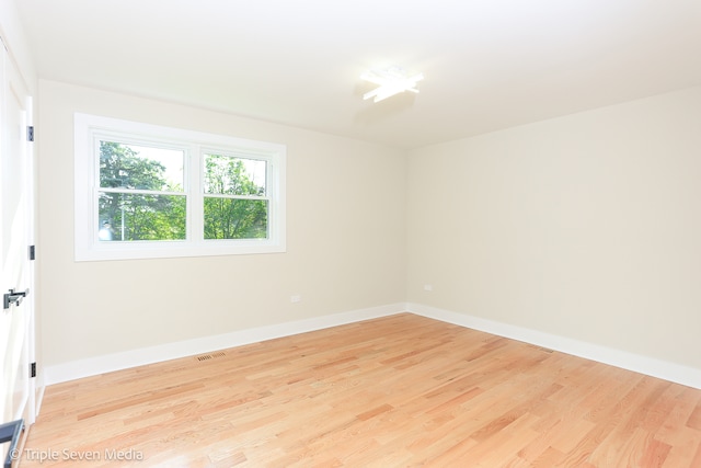 unfurnished room with light hardwood / wood-style floors