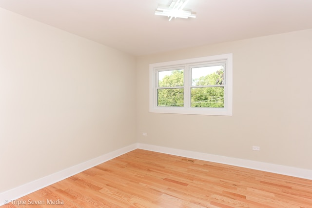 unfurnished room featuring hardwood / wood-style flooring