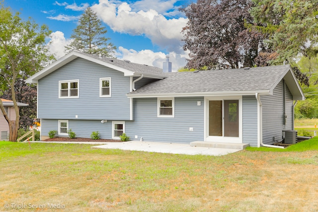 back of house featuring a yard and central AC unit