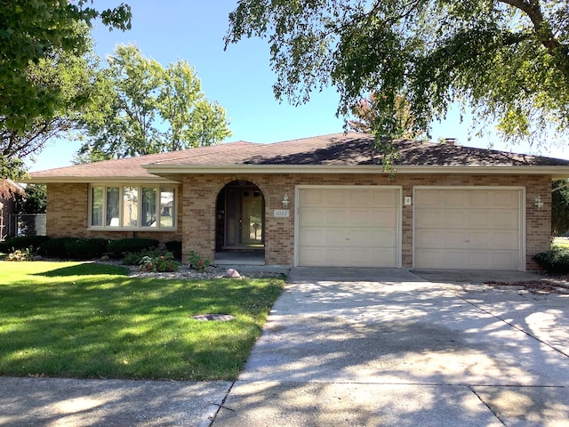 ranch-style house with a front yard and a garage