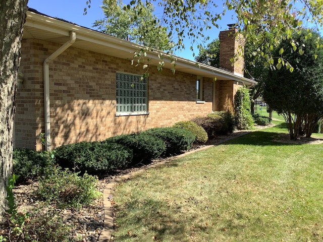 view of side of home featuring a yard