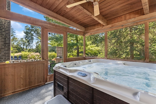 sunroom featuring ceiling fan, vaulted ceiling with beams, wood ceiling, and a hot tub