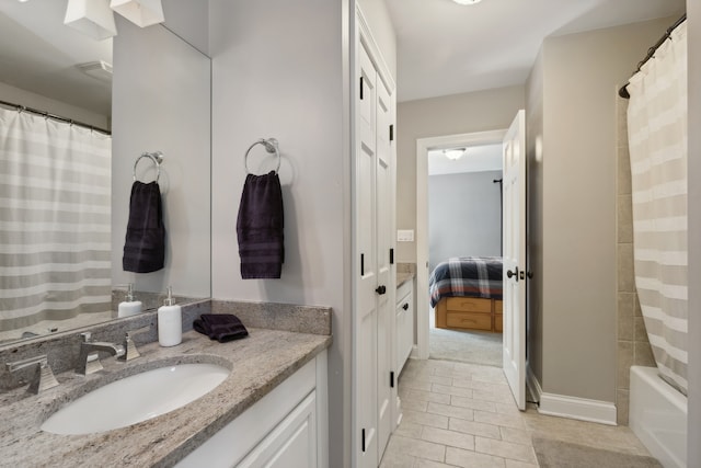 bathroom featuring shower / bathtub combination with curtain, tile patterned floors, and vanity