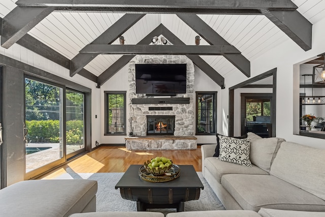 living room featuring a fireplace, beam ceiling, hardwood / wood-style floors, and high vaulted ceiling